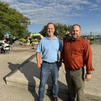 Alan Lewandowski standing with a supporter near the St. Clair River in Port Huron