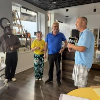 Alan Lewandowski talking with neighbors inside a Port Huron small business
